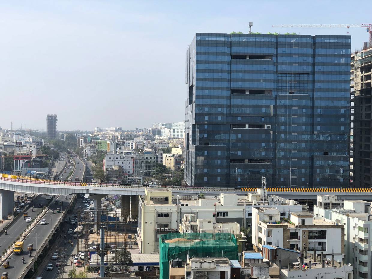 West Hyderabad skyline with the elevated corridor running past a glass office tower