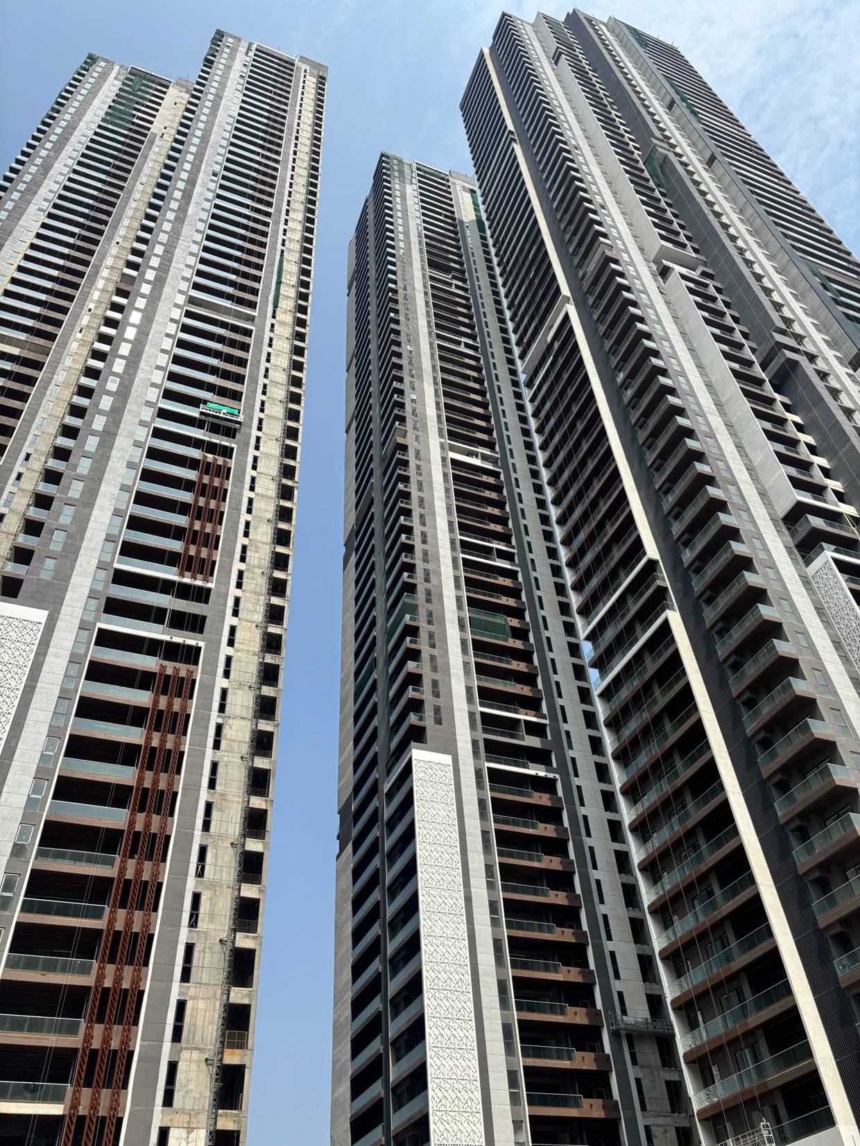 High-rise residential towers in West Hyderabad photographed from street level